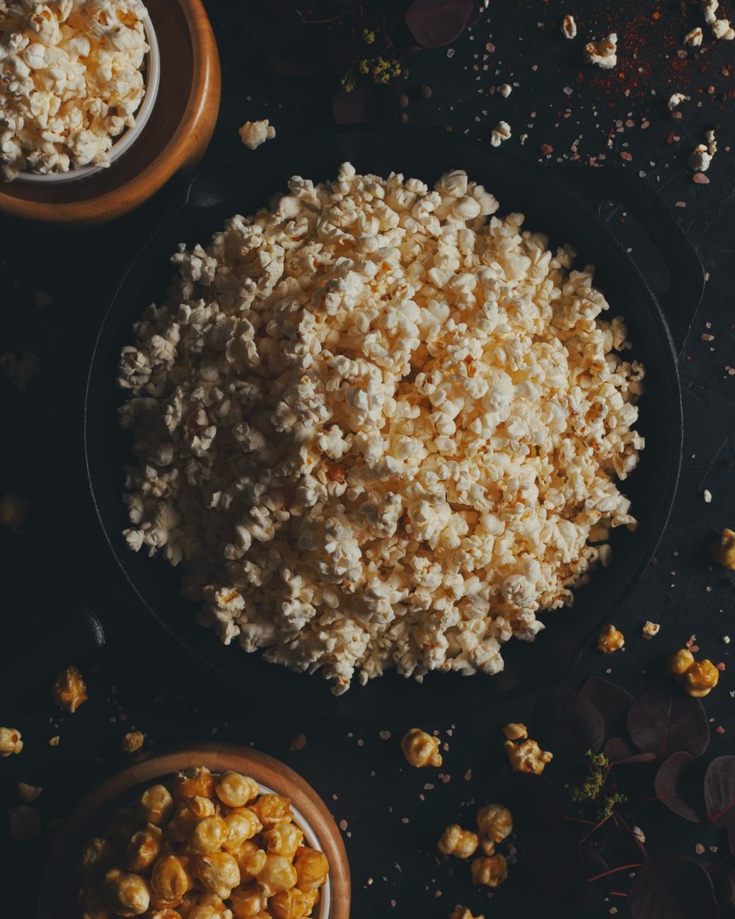 Cinematic overhead food shot — rustic bowls of popcorn